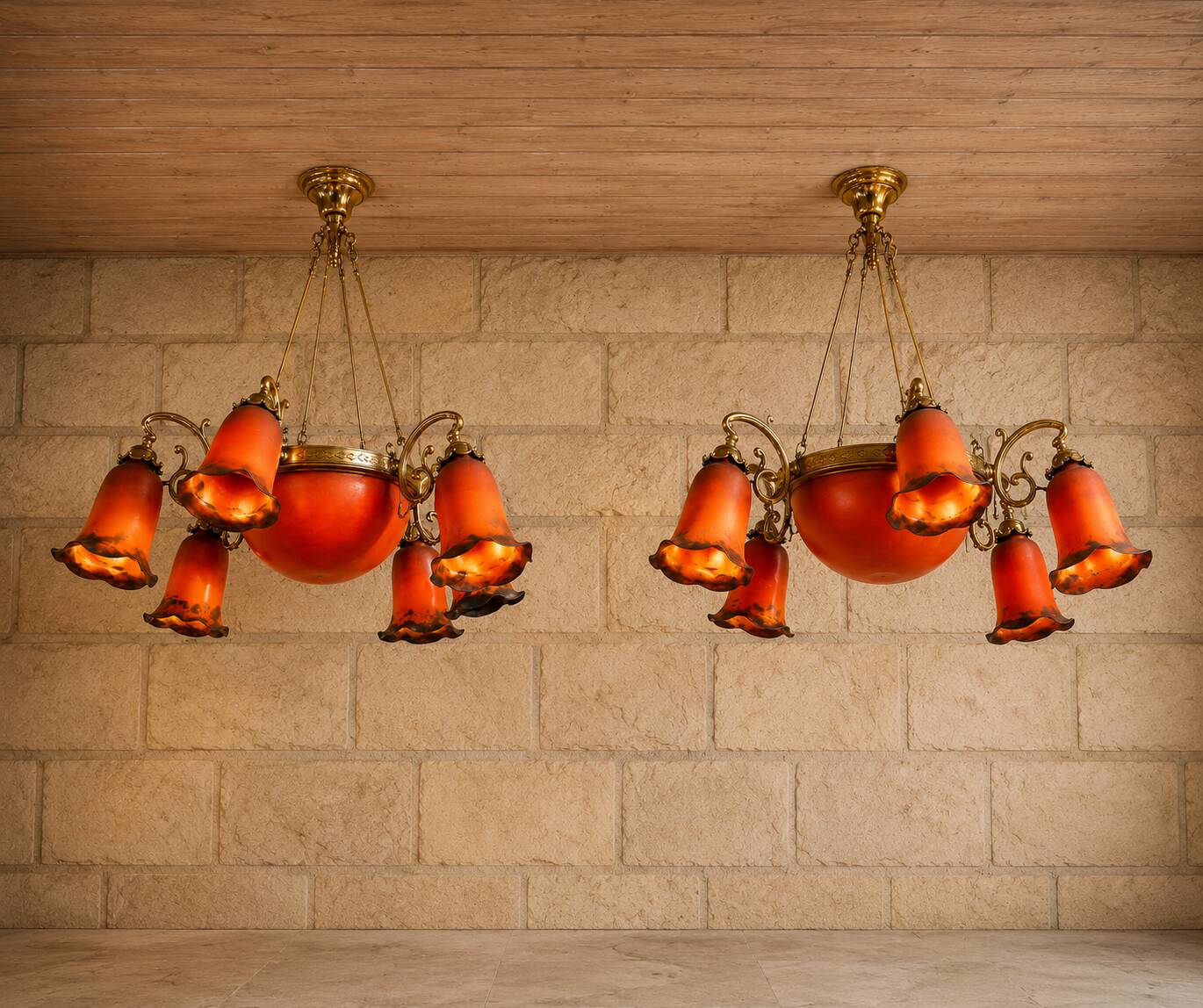 Pair of Art Nouveau style chandeliers in bronze and orange glass paste.