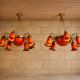 Pair of Art Nouveau style chandeliers in bronze and orange glass paste.