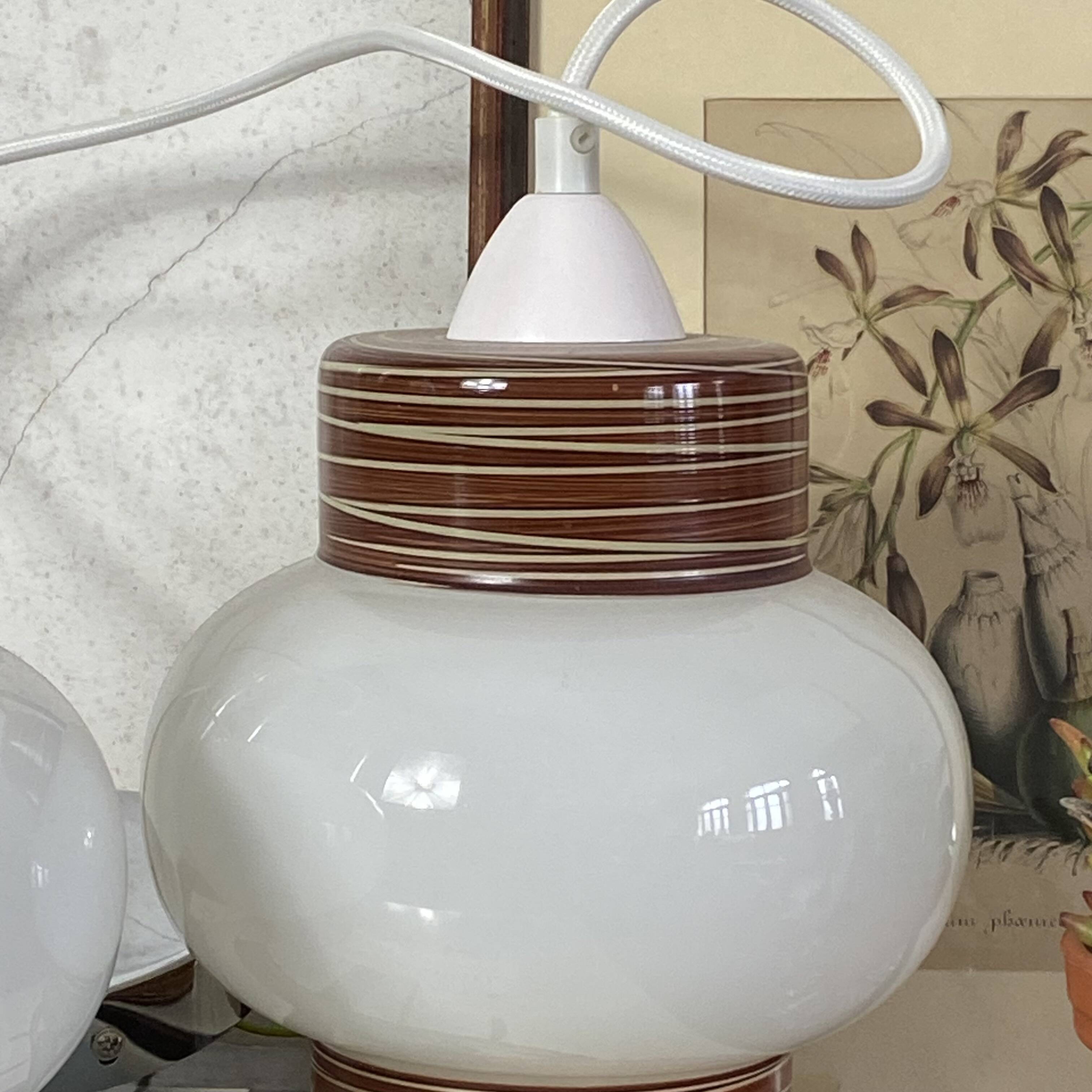 Pair of pendant lights with white glass shades from the 1950s.
