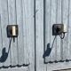 Two lion head wall sconces in tin.