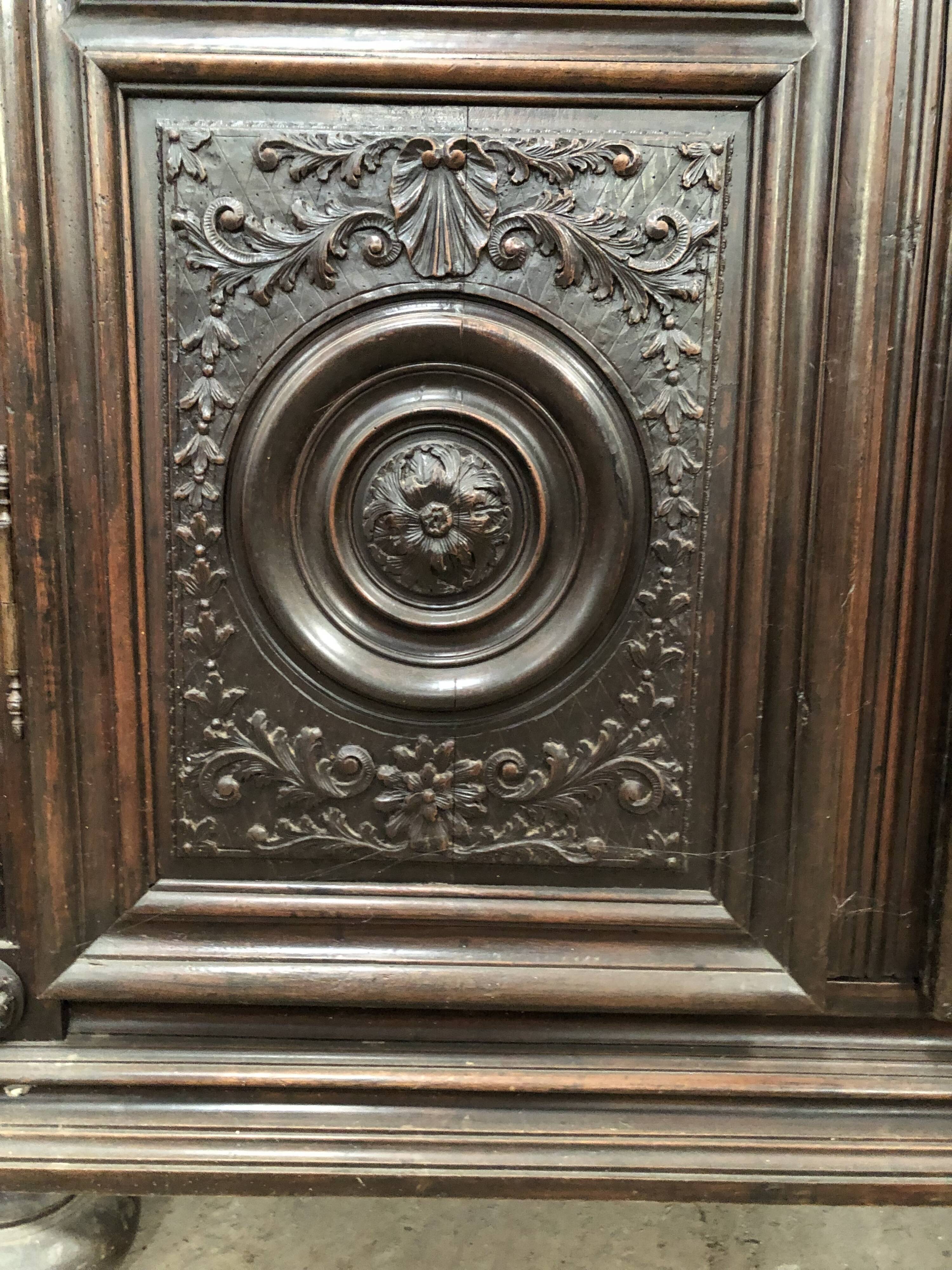 Antique Louis XIII armoire in solid walnut with carved doors