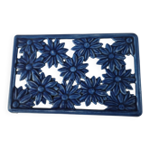 Blue cast iron trivet with flowers, small chip in the paint otherwise very good.