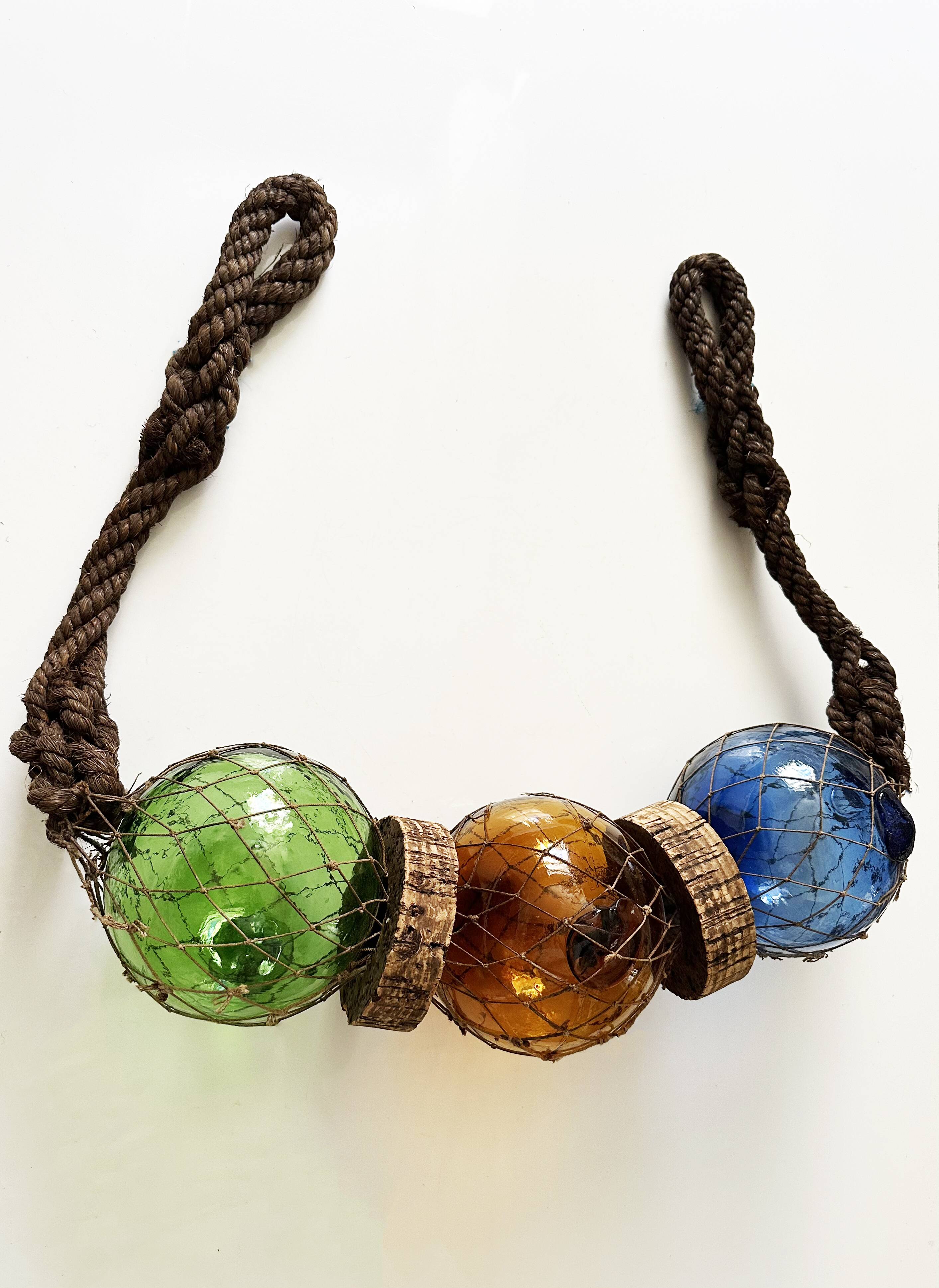 Fishing floats made of blown glass, cork, and rope. France, 1960s.