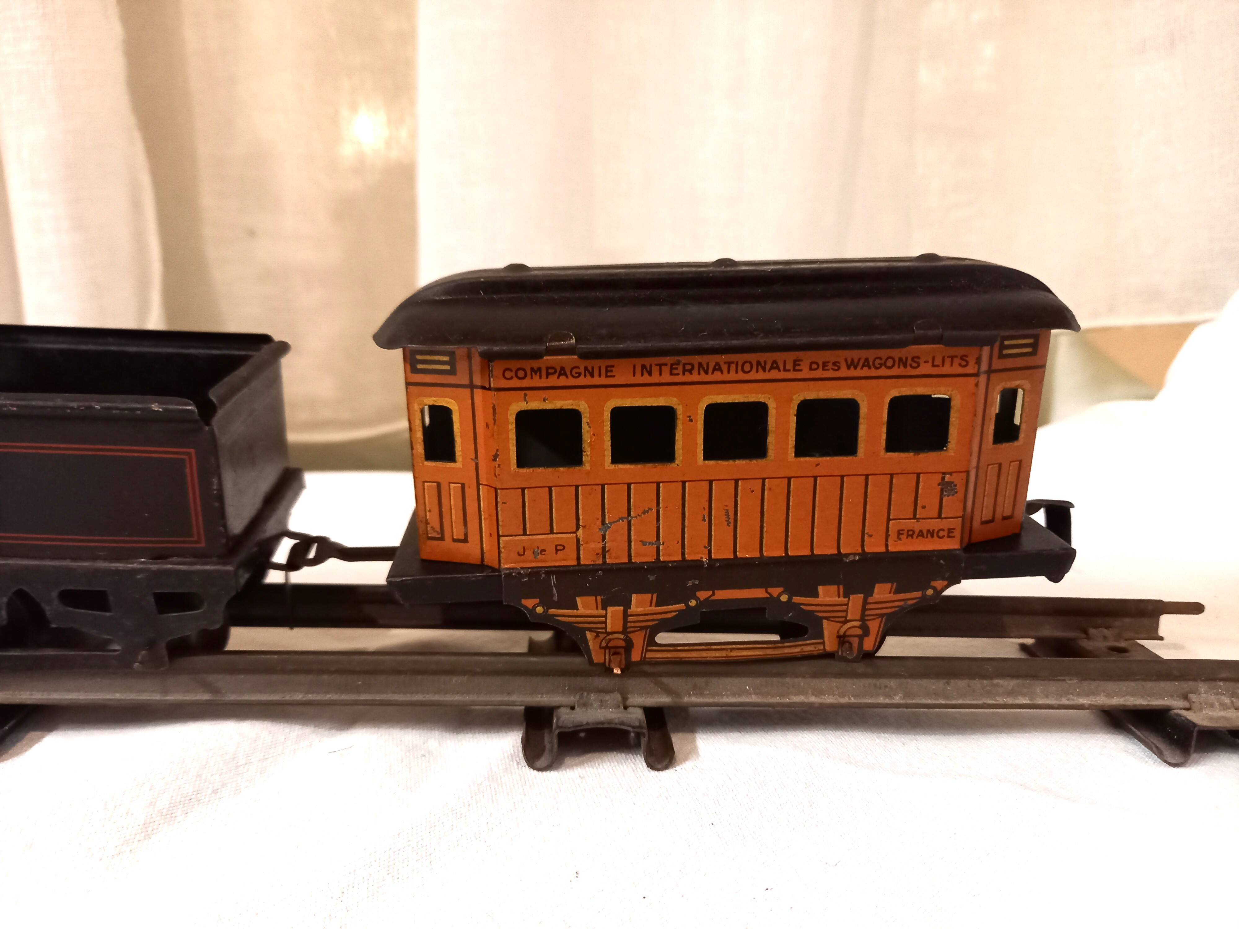 Small JEP mechanical train, including locomotive, tender, sleeping car, rail, 1930s