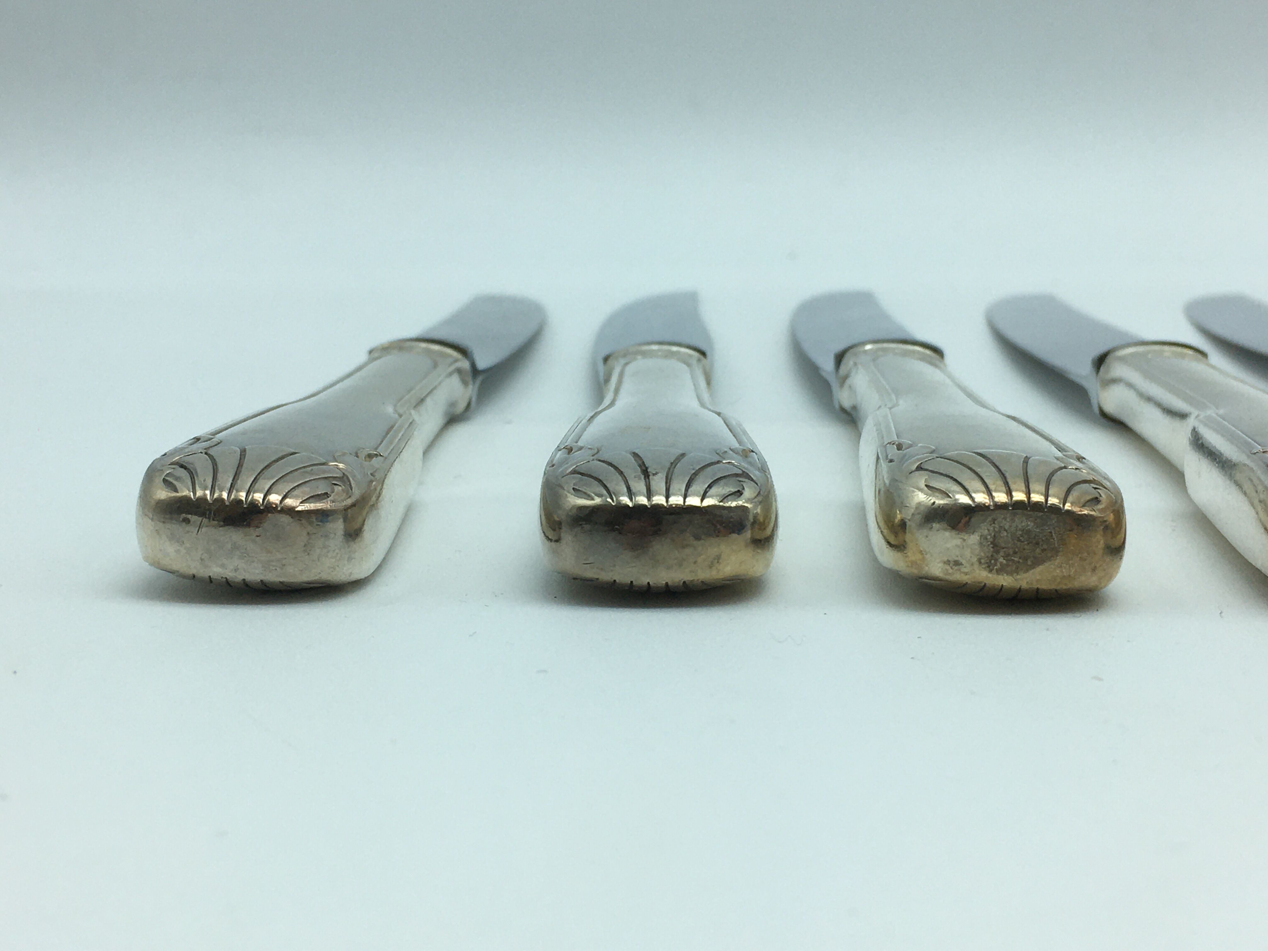 12 silver metal knives.