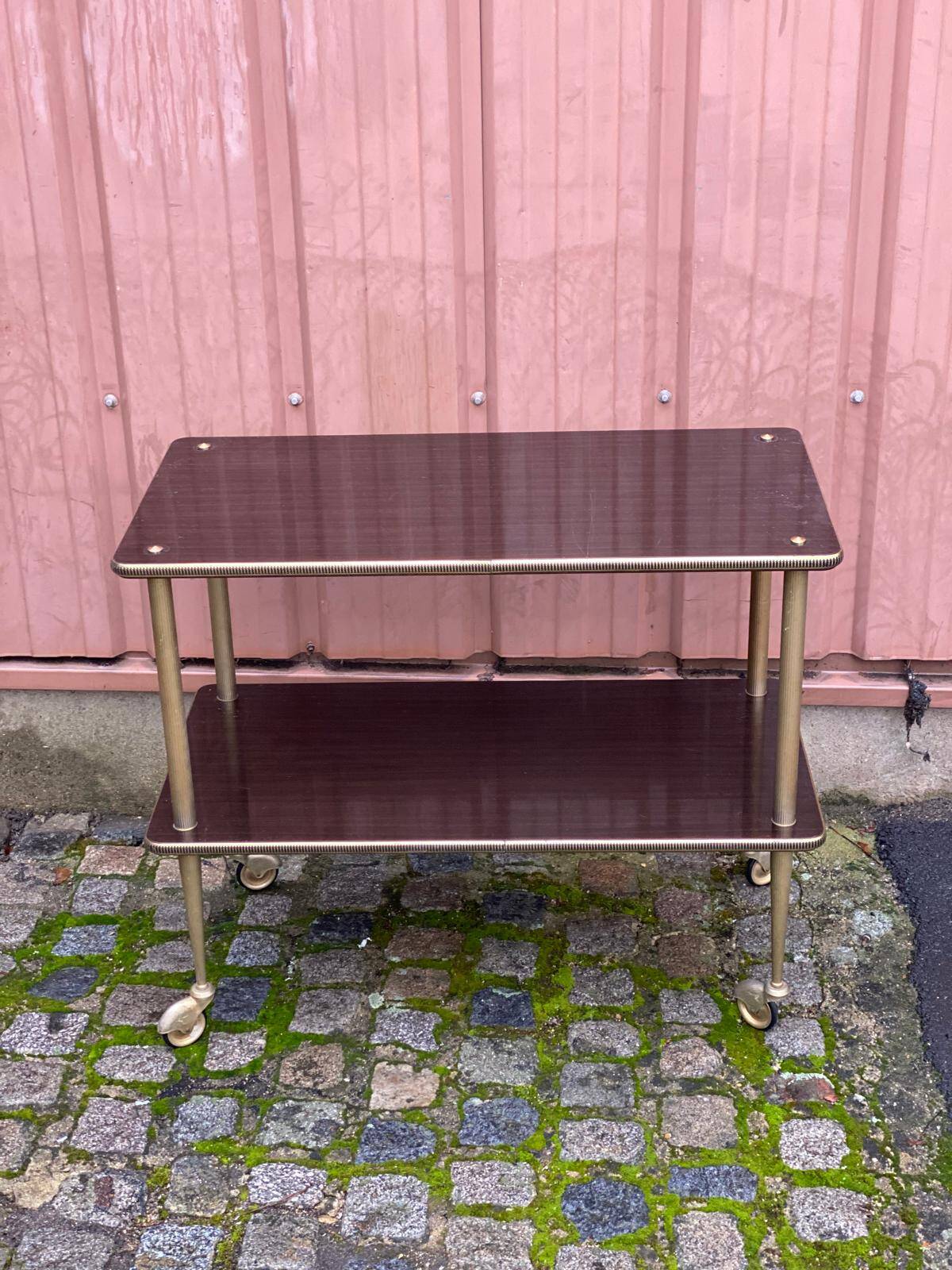 Brown rosewood rolling table with gold fluted legs