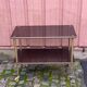 Brown rosewood rolling table with gold fluted legs