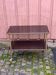 Brown rosewood rolling table with gold fluted legs