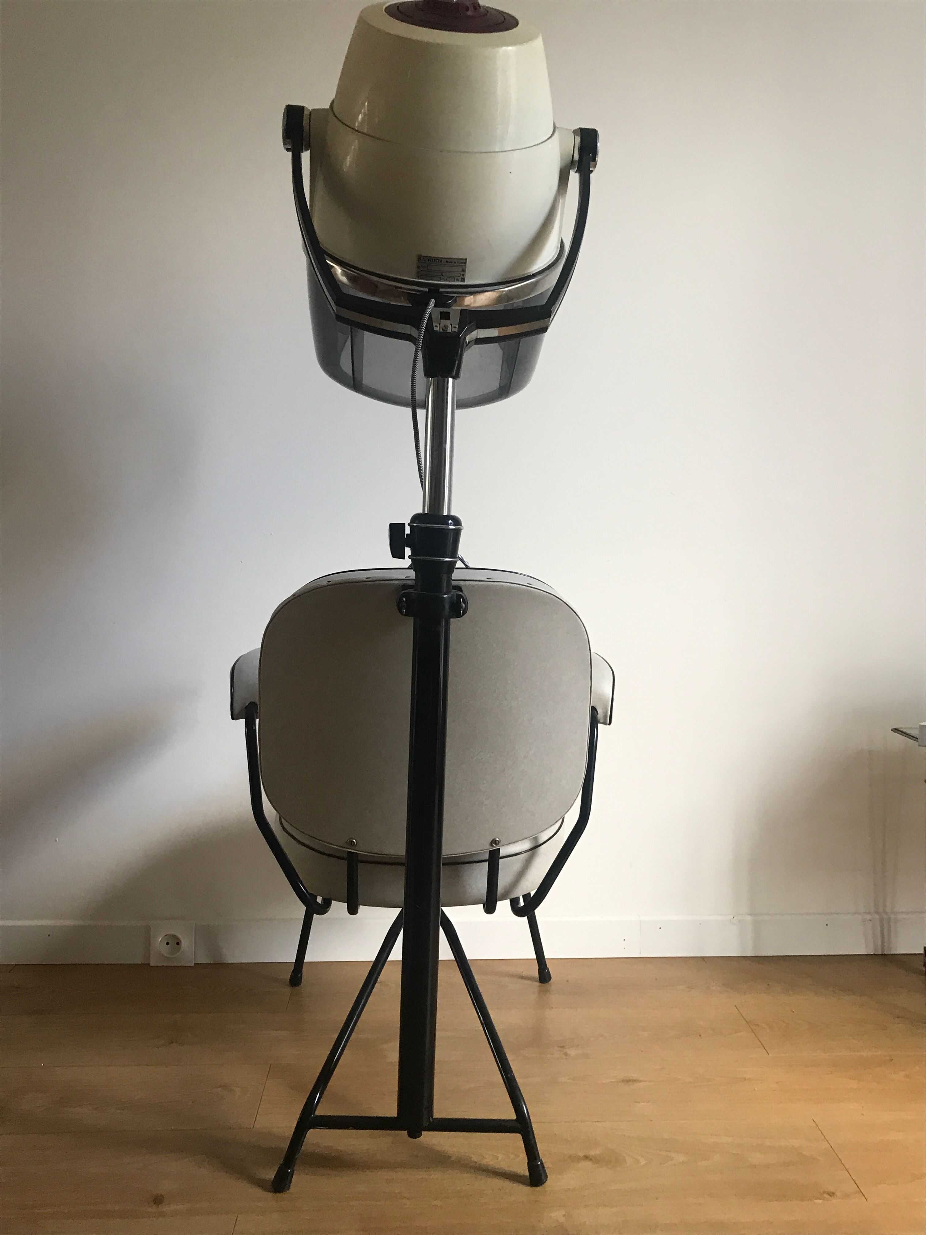 Vintage hairdresser's armchair with helmet transformed into a lamp