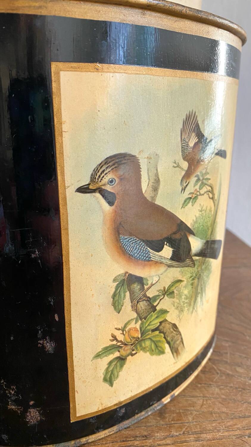 Metal wastebasket with bird decoration