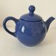 Vintage deep blue teapot, minimalist round shape.