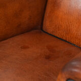 Wingback chair made of sheep leather with black piping in good condition