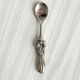 Antique small spoons with a metal bow design