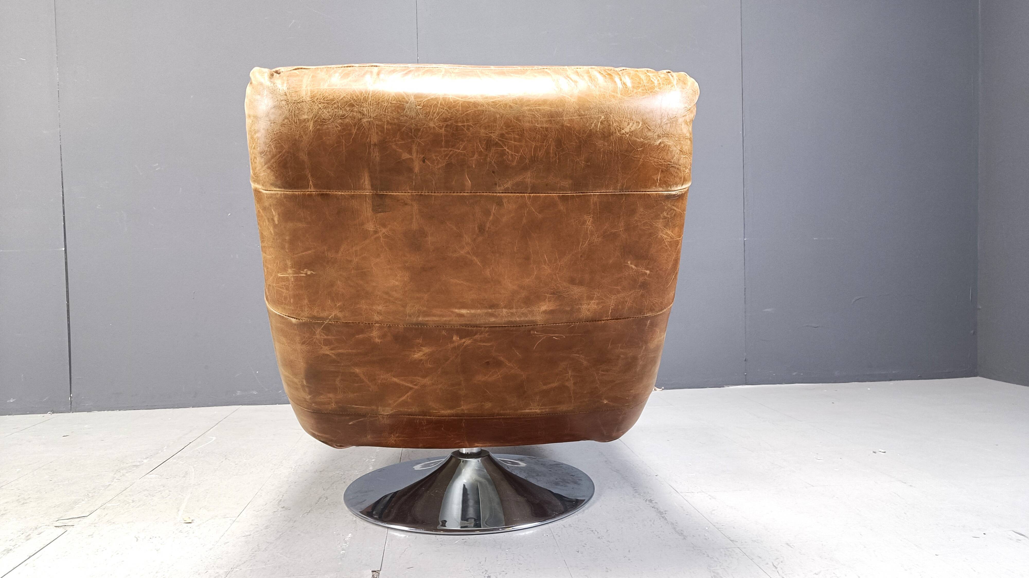 Vintage leather swivel chair with stool, 1970s