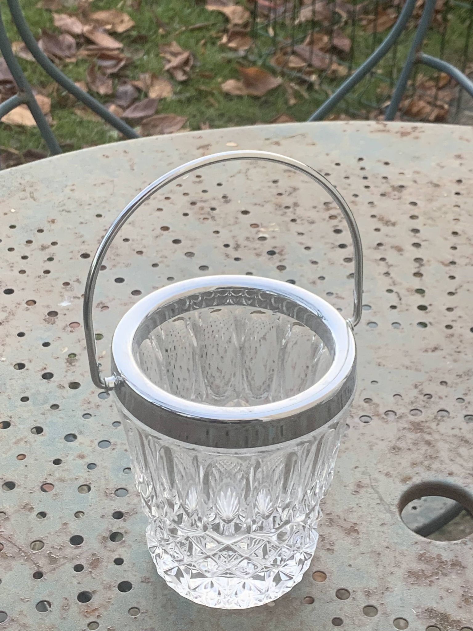 Whiskey carafe and ice bucket in transparent glass and silver-colored metal handle