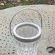 Whiskey carafe and ice bucket in transparent glass and silver-colored metal handle