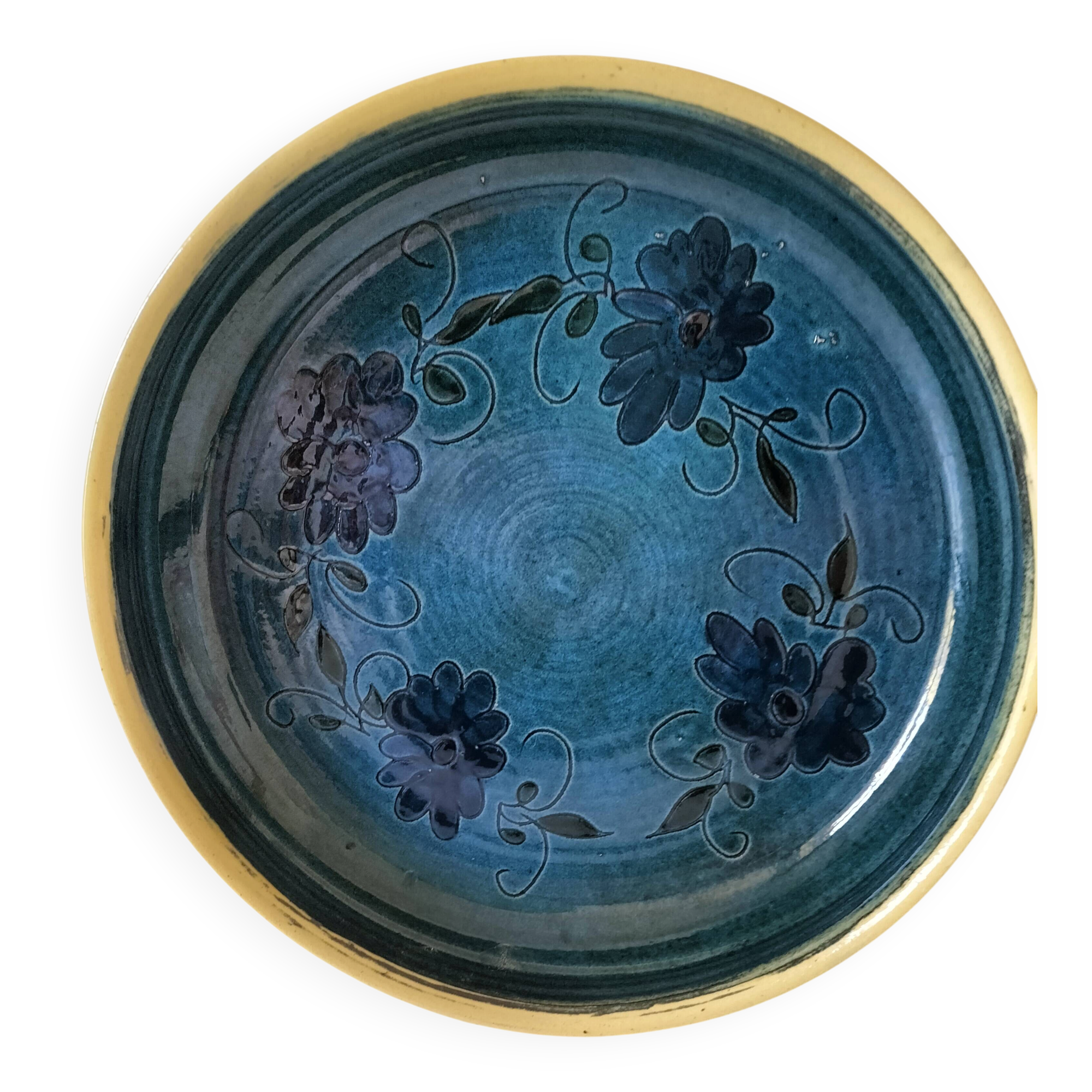 Blue floral glazed stoneware plate with a yellow rim.