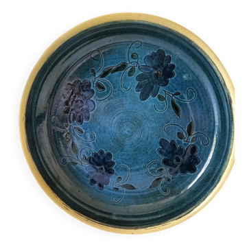 Blue floral glazed stoneware plate with a yellow rim.