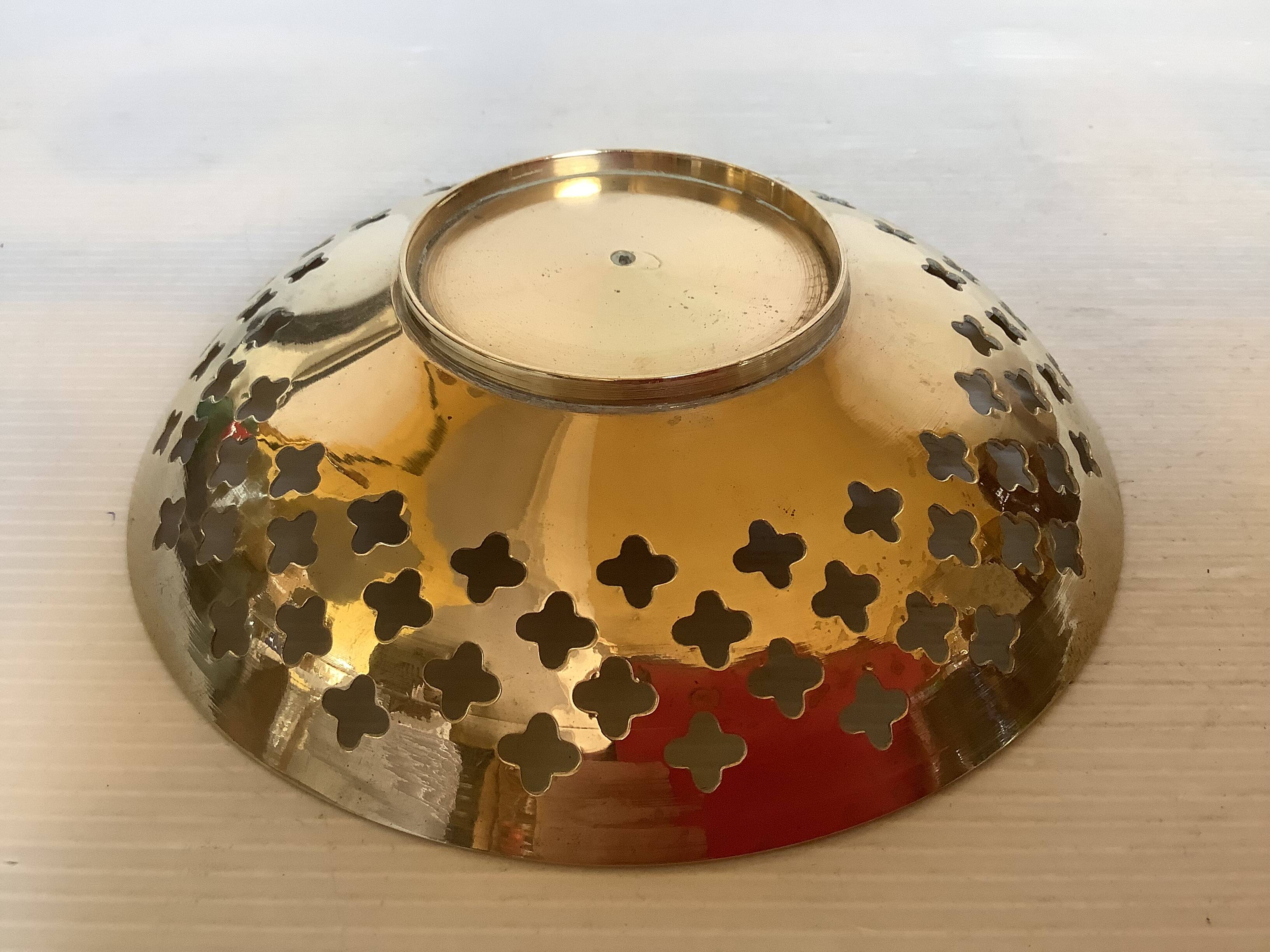 Lattice brass catchall and candlestick.