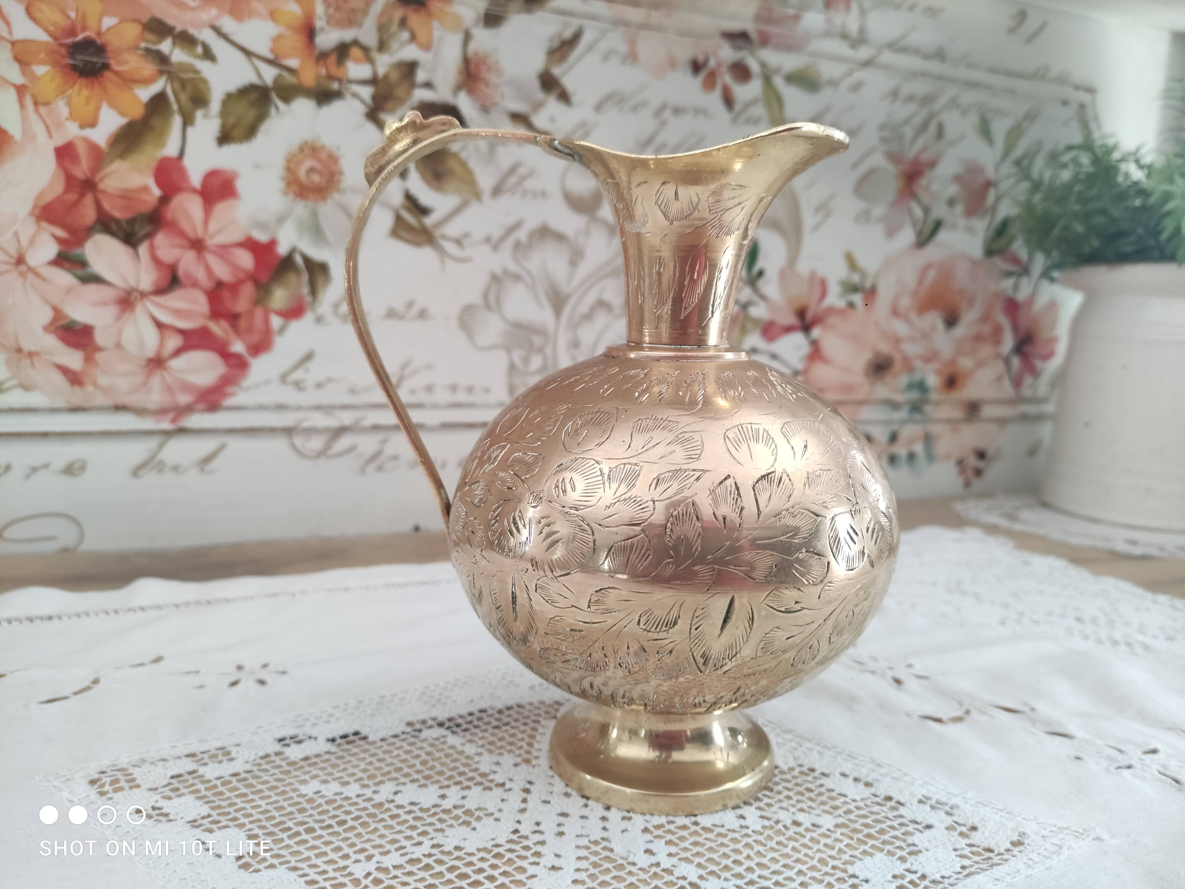 Chiseled brass pitcher decorated foliage