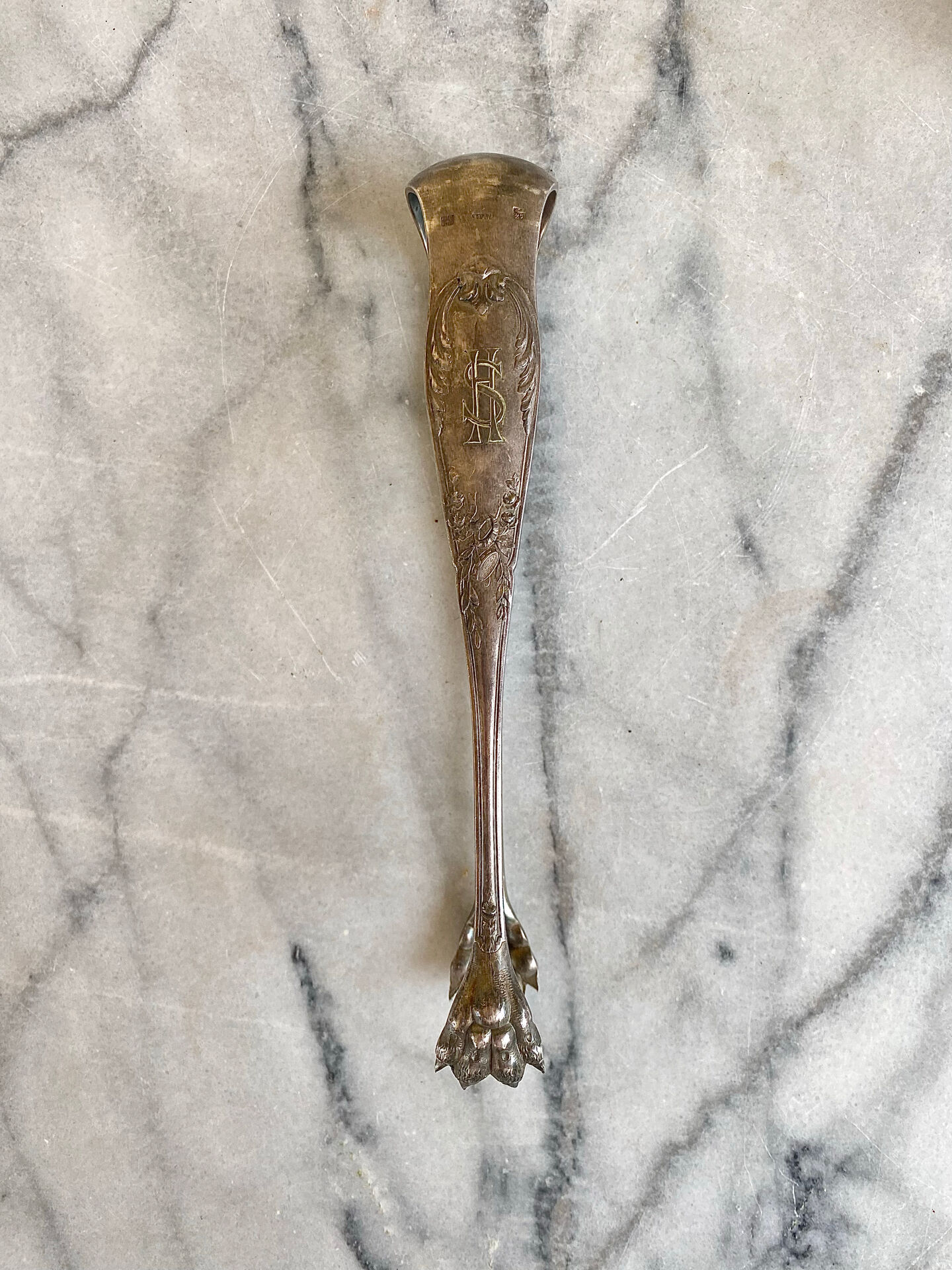 Antique silver-plated sugar tongs SFAM with monogram.