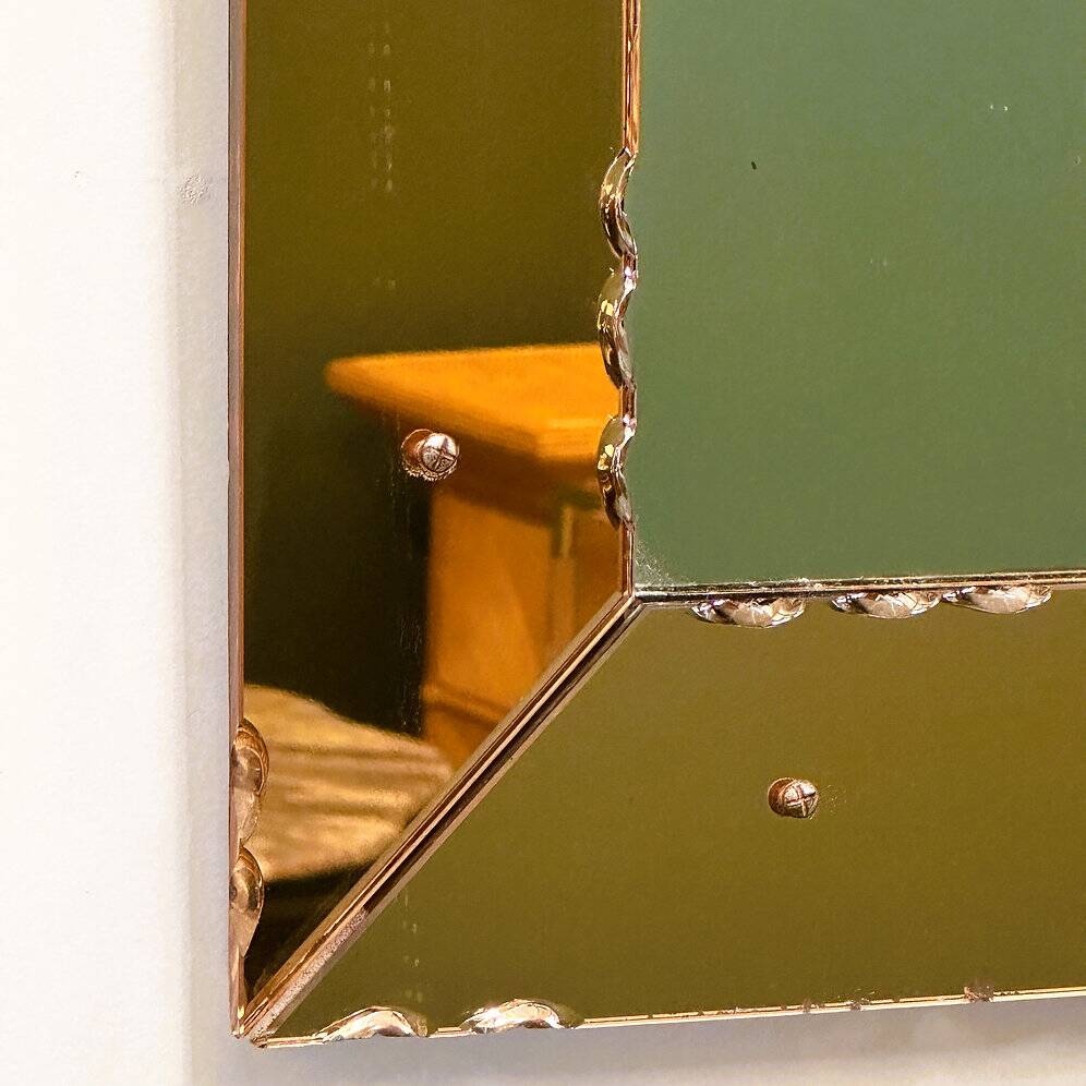 Striking French amber-coloured mirror with sculpted edge details, 1940s