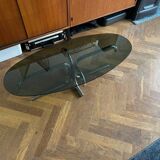 70s design oval coffee table in smoked black glass with chrome legs.