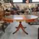 Round Regency dining table in mahogany and green leather with extensions - 20th century