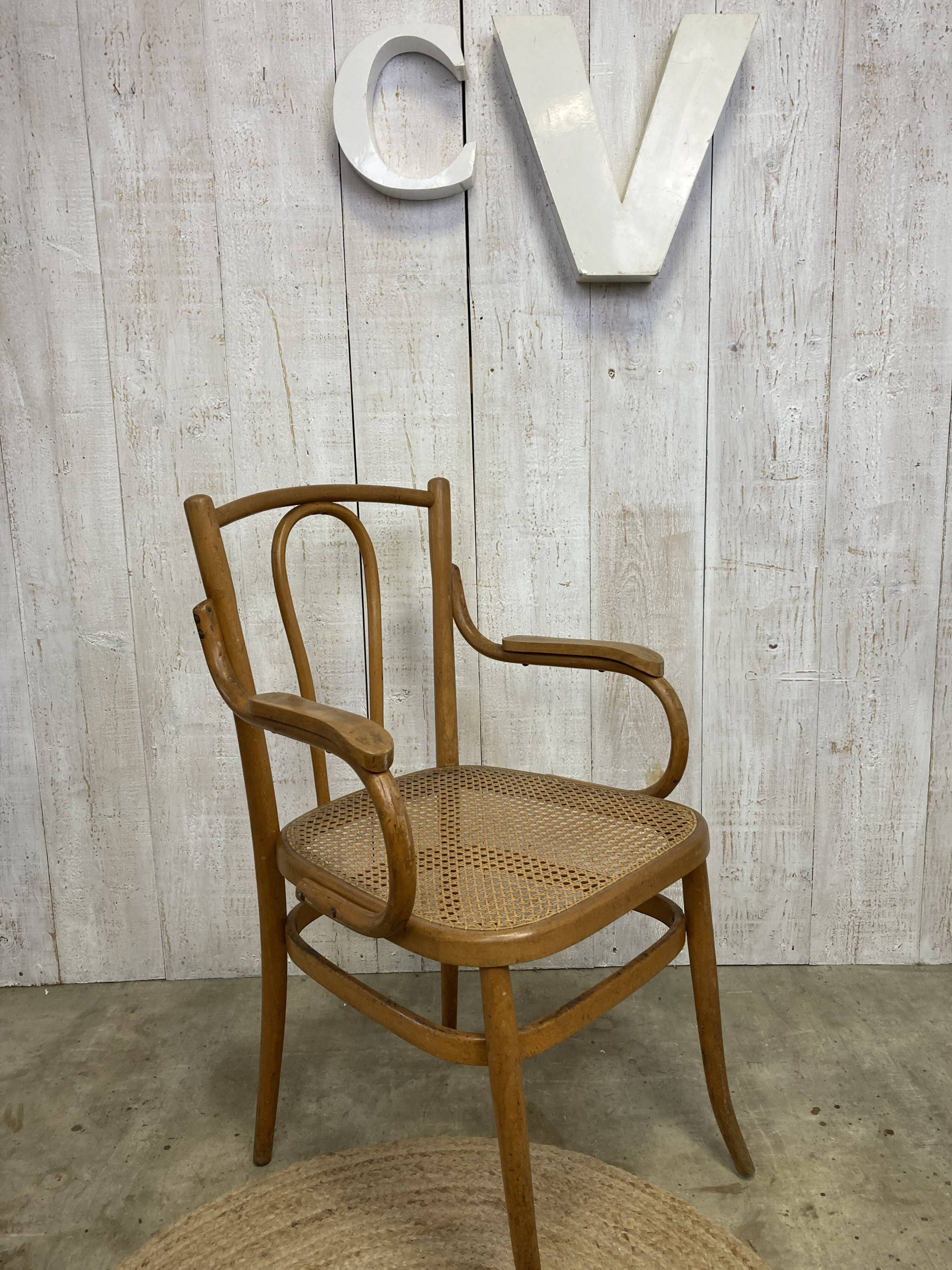 Curved wood and cane armchair