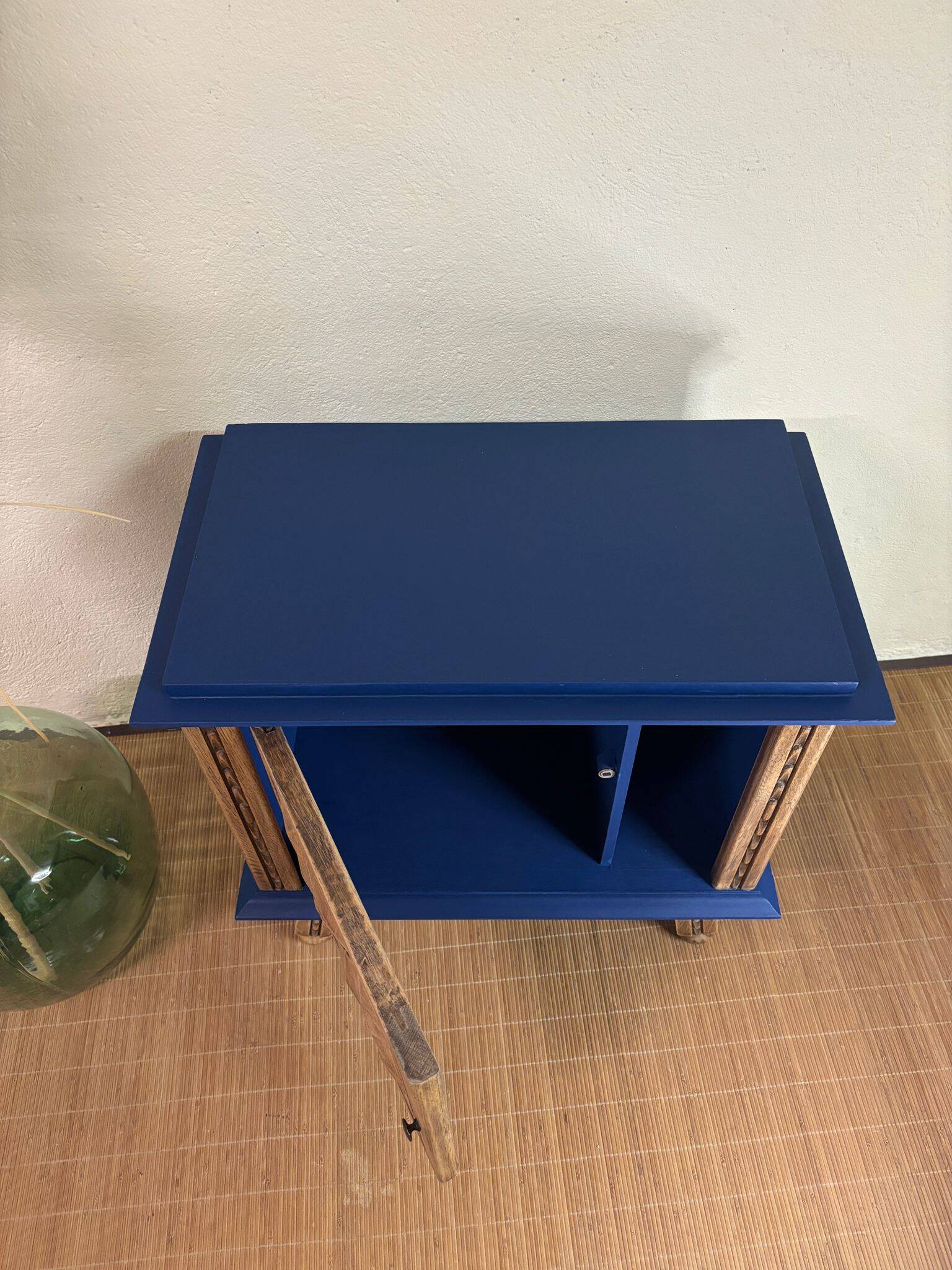 Small vintage upcycled side table in midnight blue and raw wood, with a rose-shaped door.