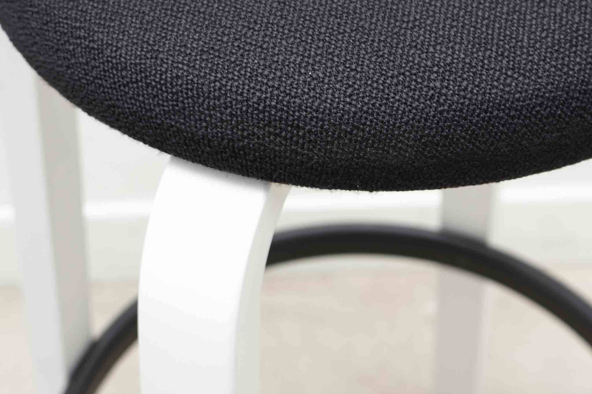 Alvar Aalto 64 stool upholstered in black and white for Artek.