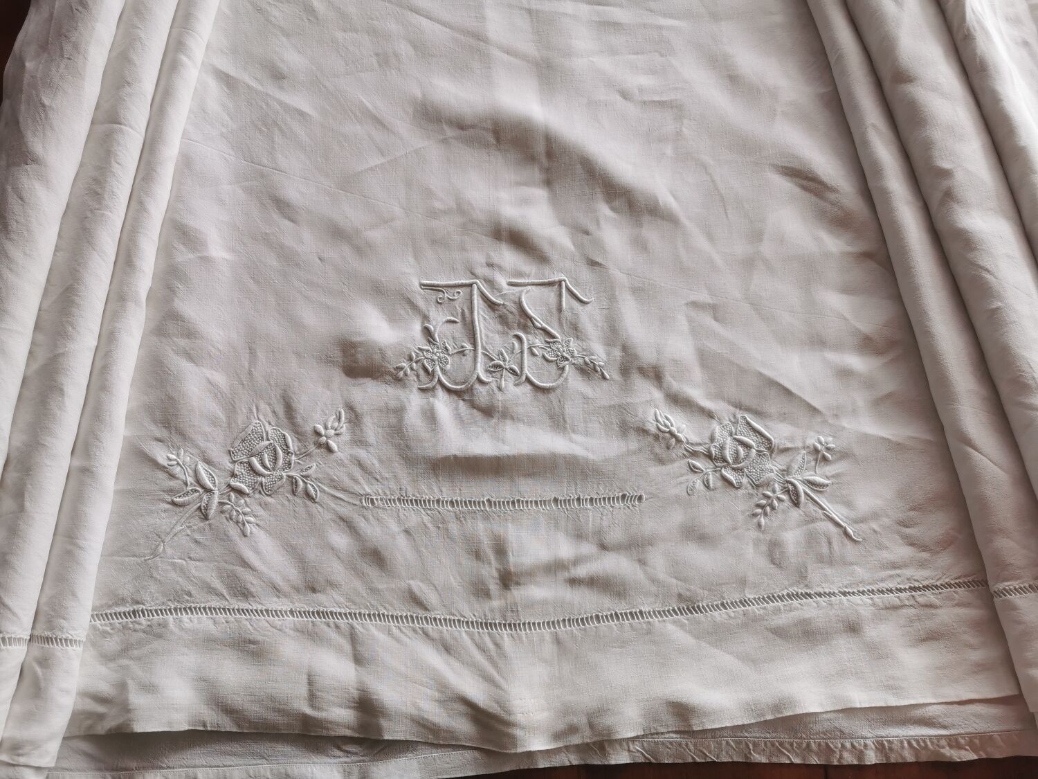 Antique embroidered linen sheet with a monogram.