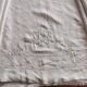 Antique embroidered linen sheet with a monogram.