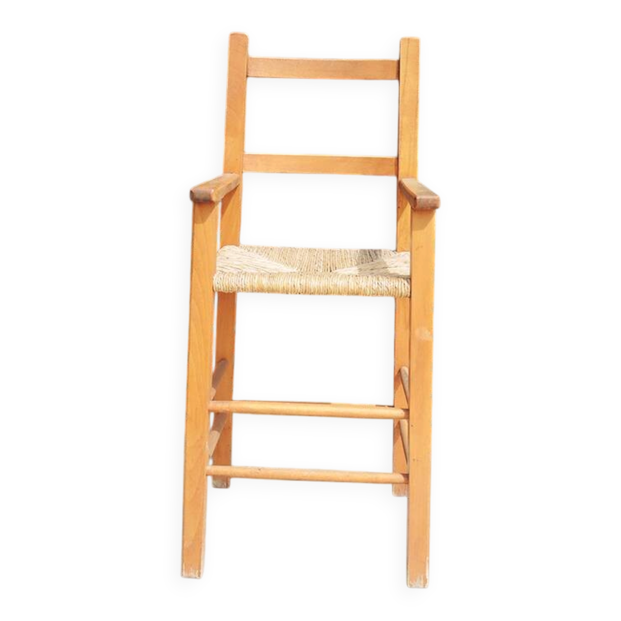 Old wooden high chair for children with straw.