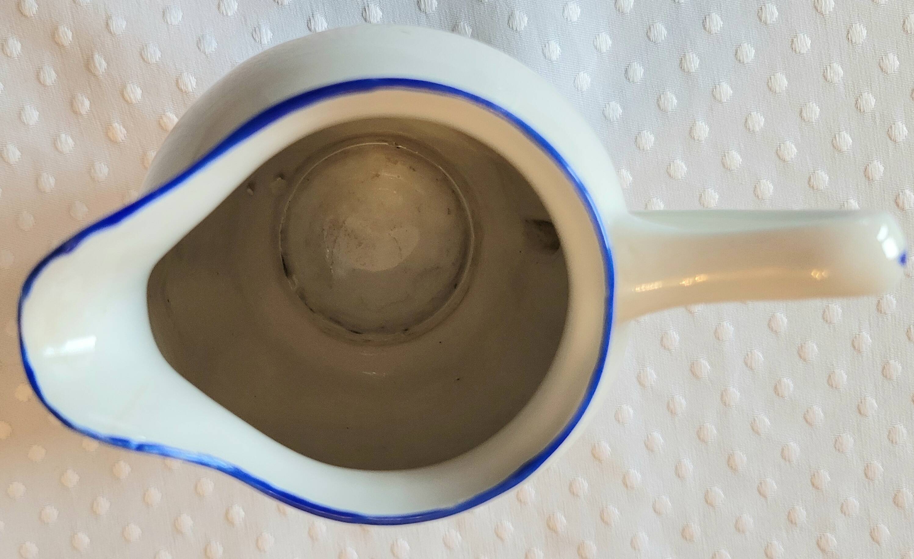 Blue and white ceramic coffee service with flowers.
