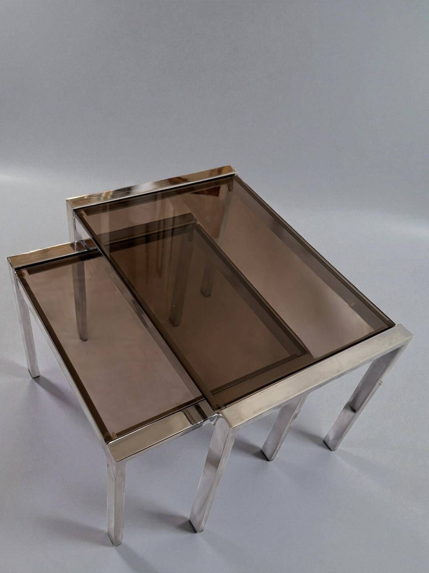 Vintage nesting tables from the 1970s, chrome and smoked glass, mid-century modern.