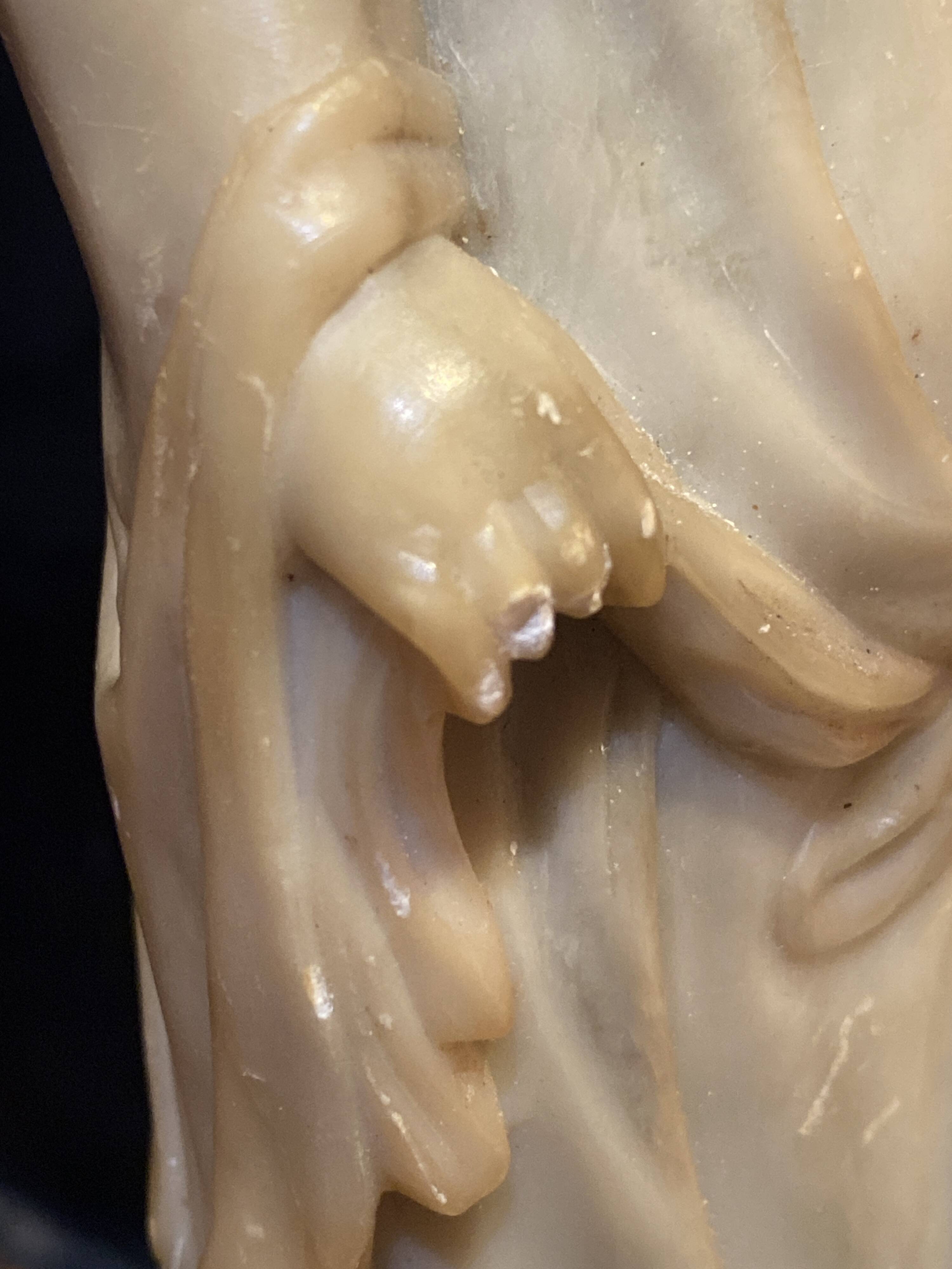 Soapstone sculpture on obsidian base of a Buddhist.