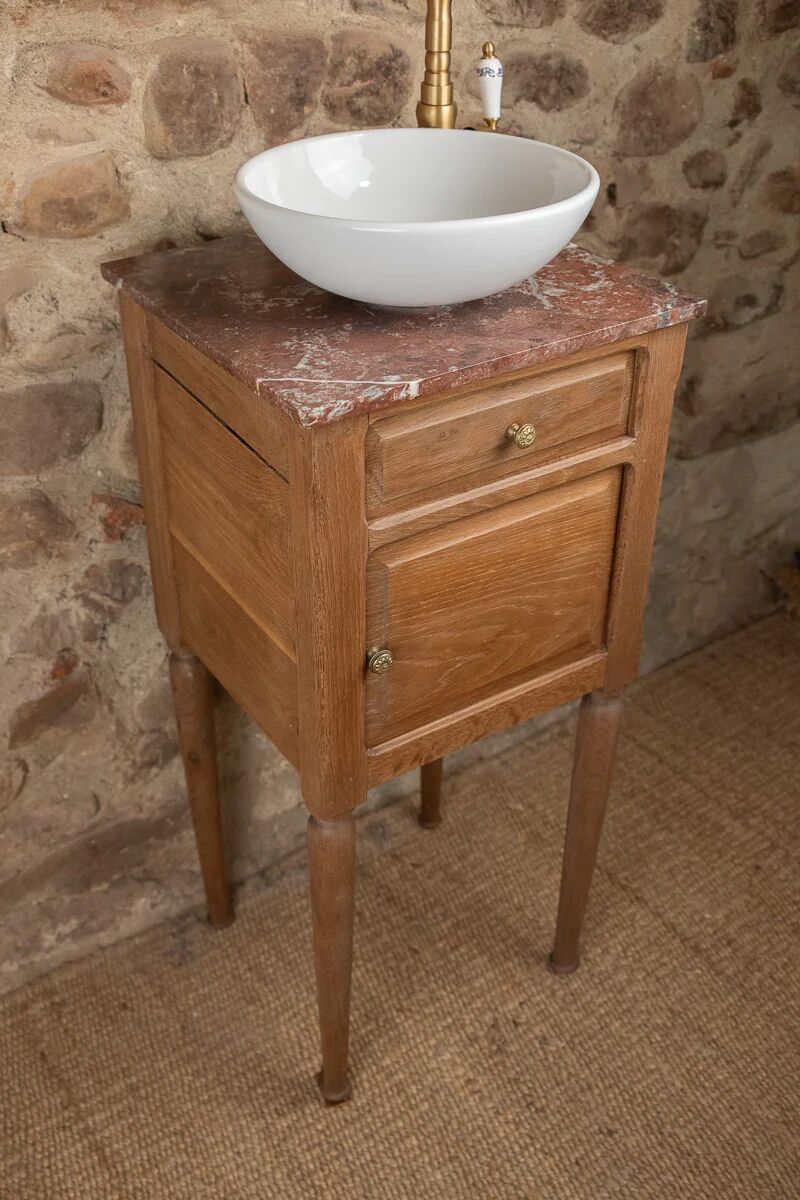 Small antique washbasin in wood and red marble.