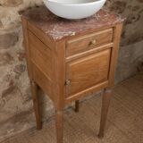 Small antique washbasin in wood and red marble.