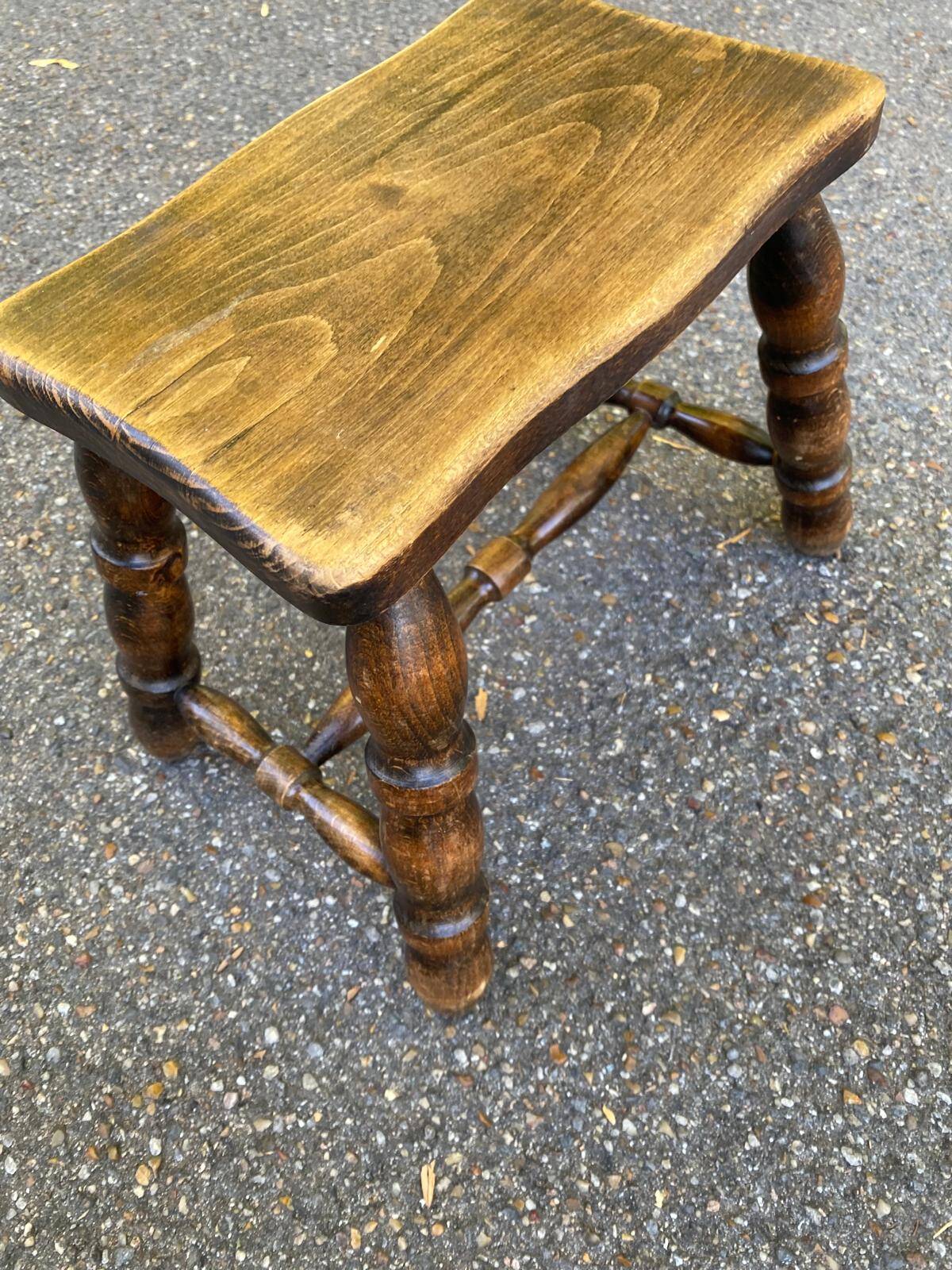 Small vintage low stool made of turned solid wood footrest 1960