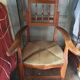 Beau fauteuil ancien au dossier haussable et assise en paille
