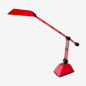 Red plastic and metal desk lamp with adjustable arm and head