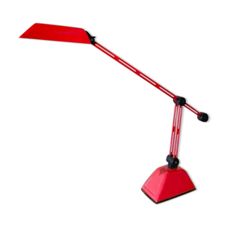 Red plastic and metal desk lamp with adjustable arm and head