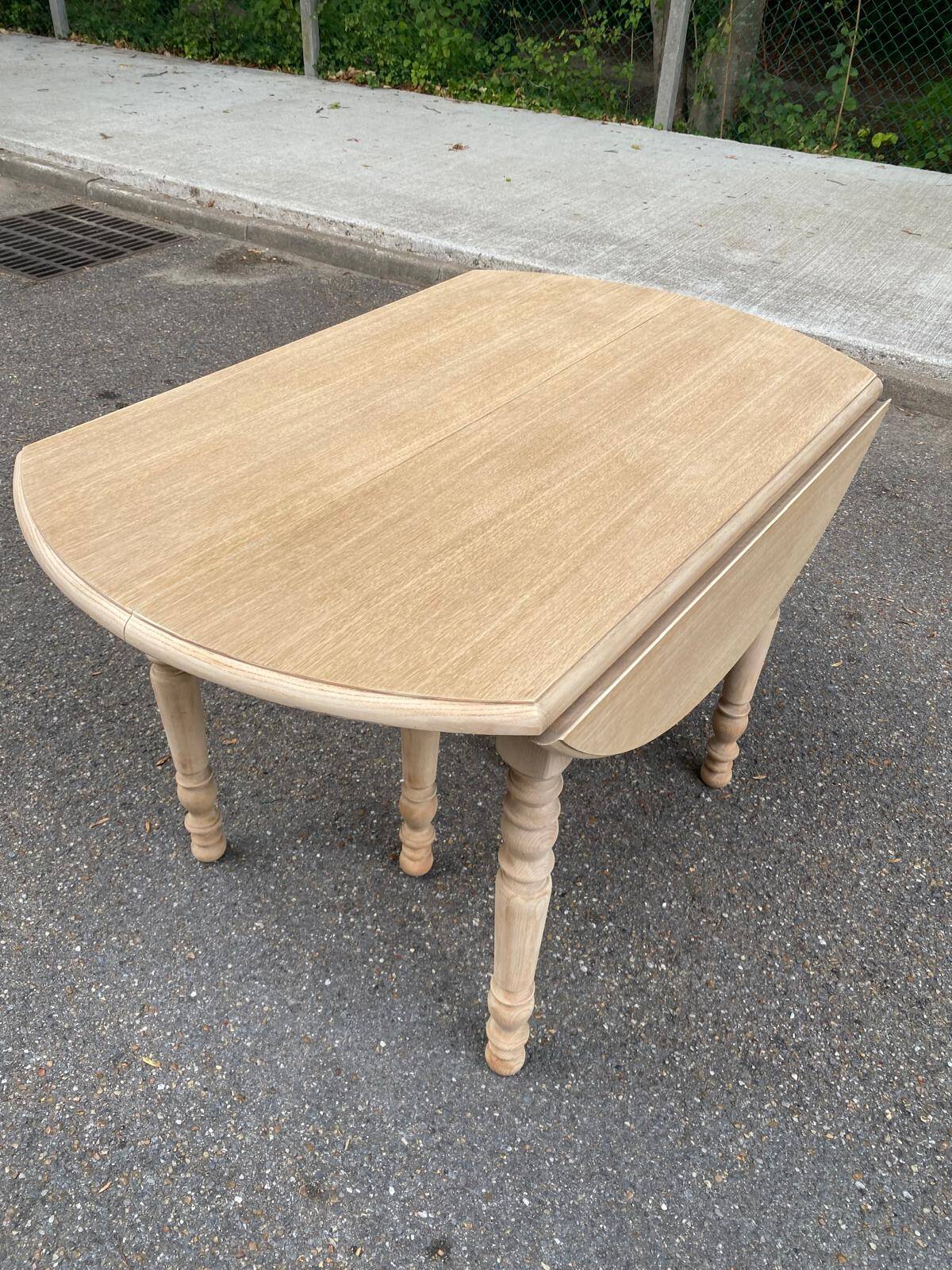 Round dining table with extendable leaves, Louis Philippe style, stripped in raw oak.