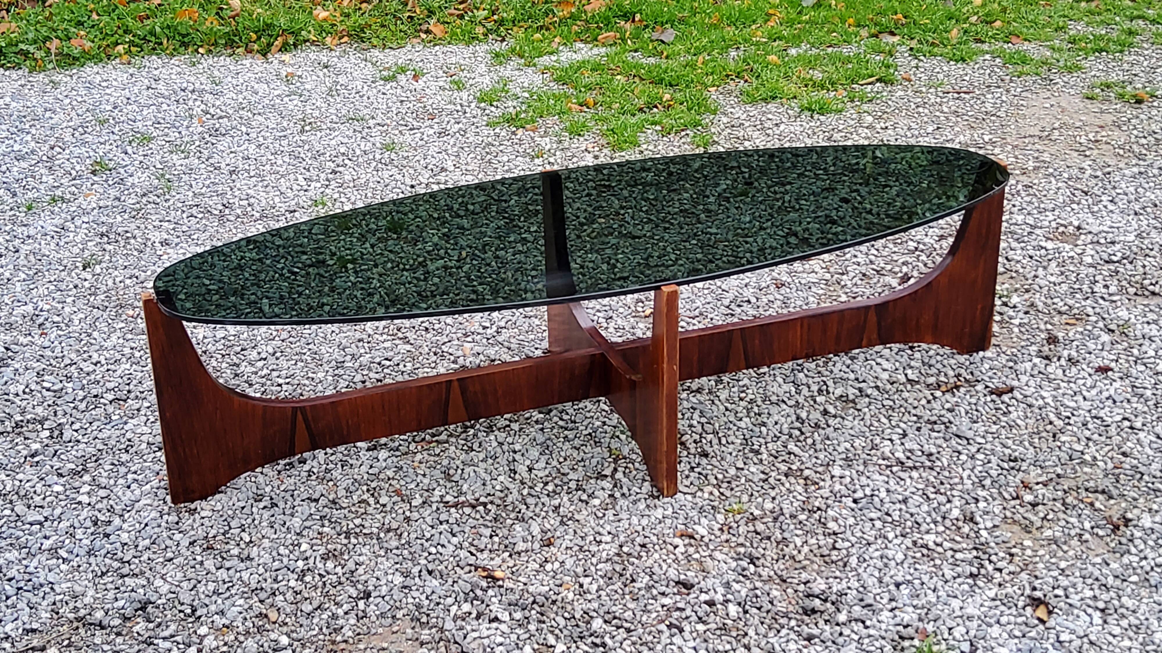 Designer coffee table by Hugues Poignant in rosewood and smoked glass from the 70s