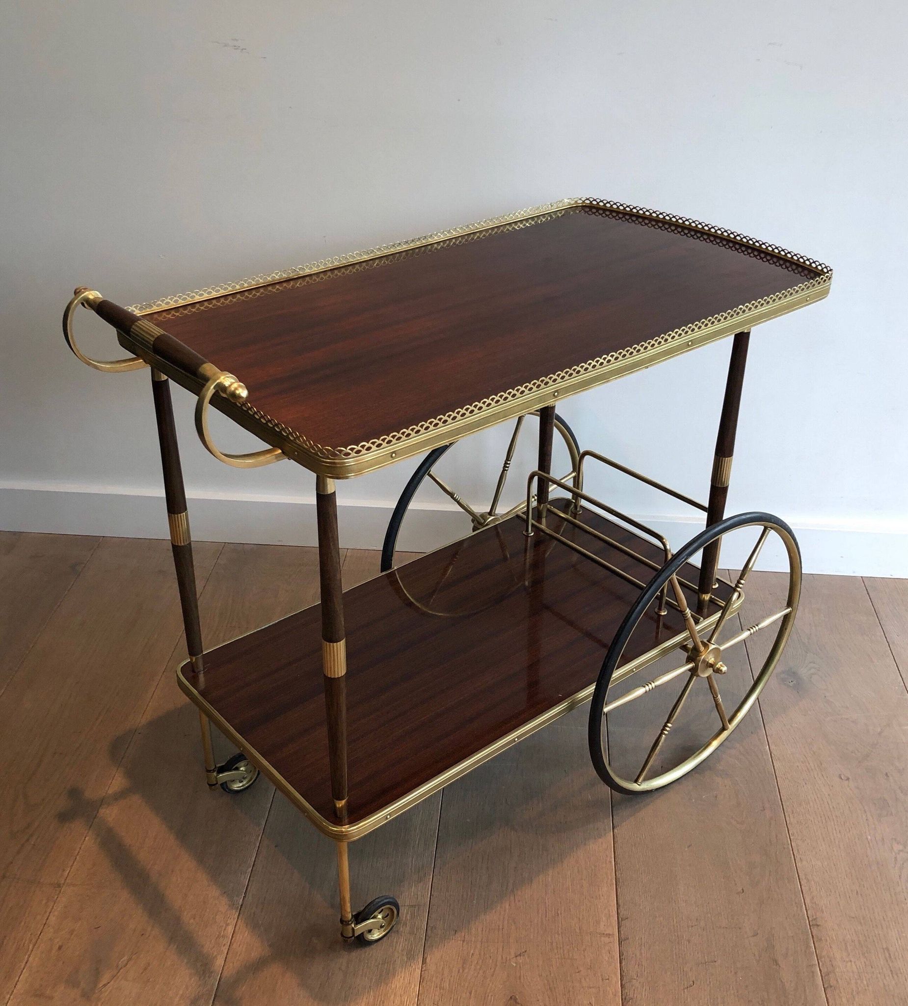 Mahogany and brass rolling table in the style of Maison Jansen.