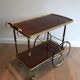 Mahogany and brass rolling table in the style of Maison Jansen.
