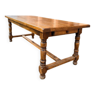 Large farmhouse table made of solid wood.