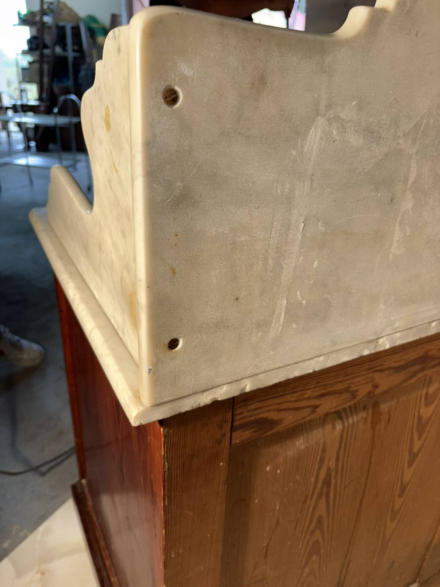 Antique wood and marble kitchen sideboard with carved backsplash