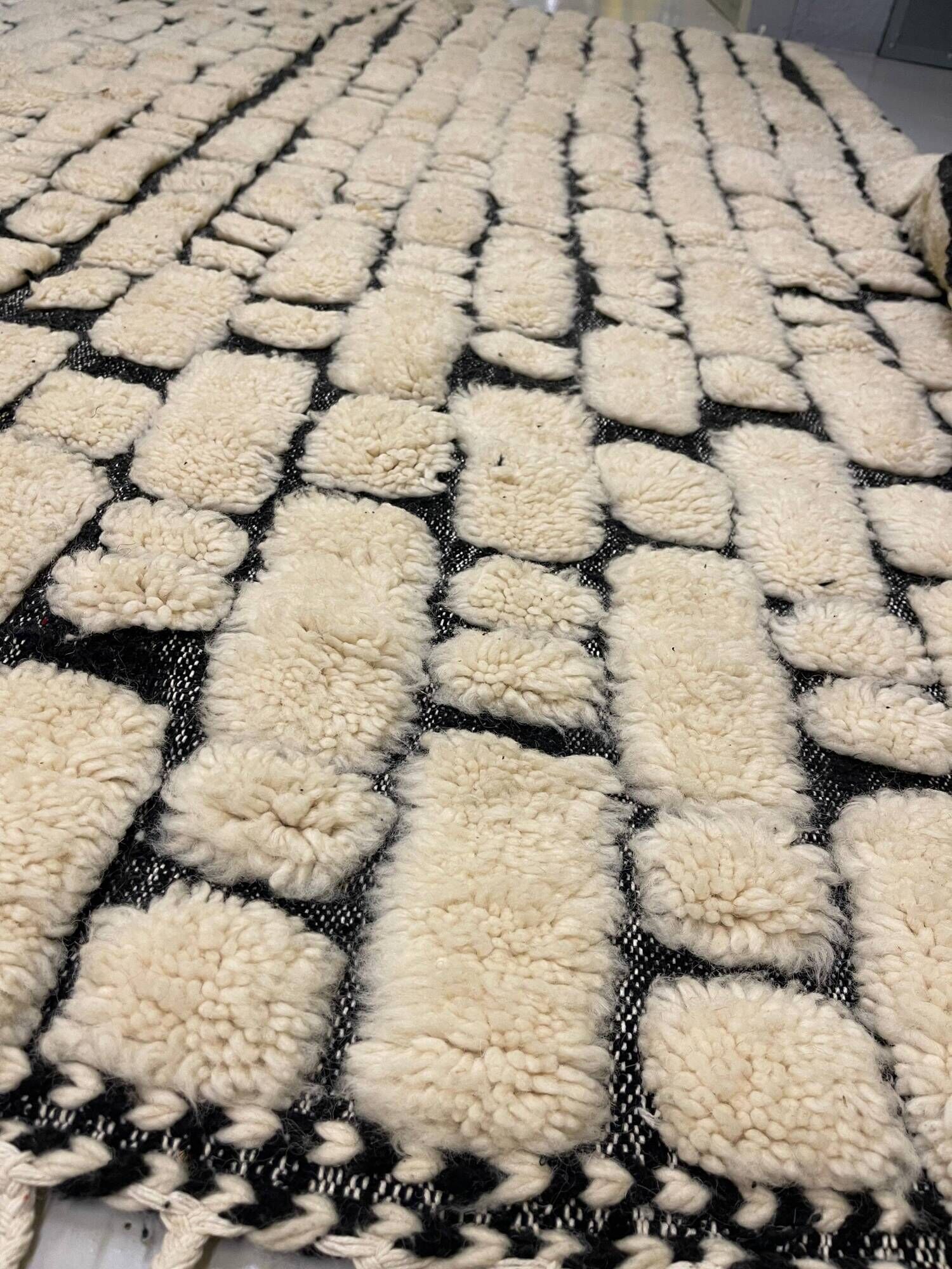 Large cream and black checked Berber rug, 280 × 200 cm.